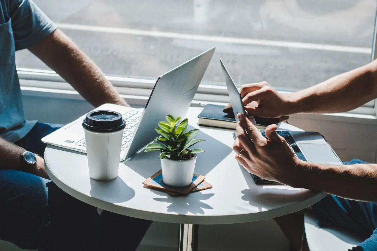 two person with a laptop on a table